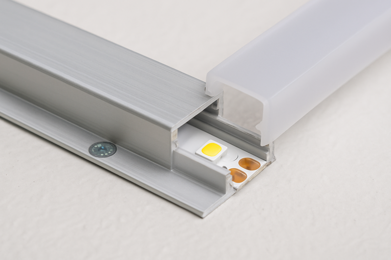 A detailed image showing the final step: a silicone-filled end cap being placed over a freshly soldered connection on an LED strip.