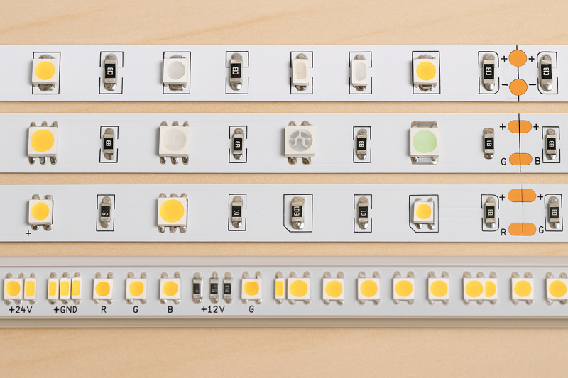 An image showing several different types of LED strips laid out side-by-side, highlighting the differences in chip size and color.