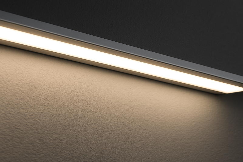 A perfectly installed LED strip inside an aluminum channel, casting an even, diffused glow on a textured wall
