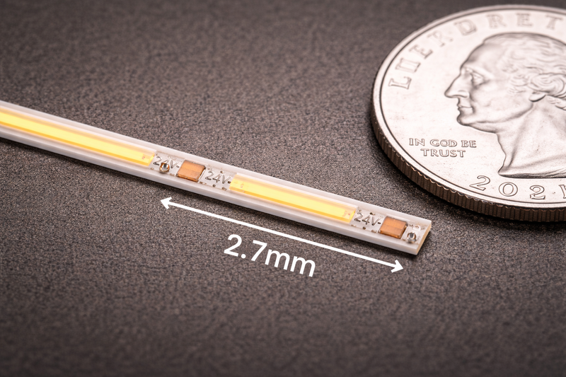 Macro shot of a 2.7mm LED strip compared to a coin, showing its tiny size.
