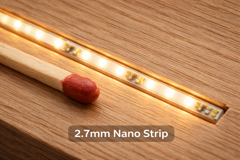 Macro shot of a 2.7mm LED strip next to a matchstick, installed in a tiny groove in wood.