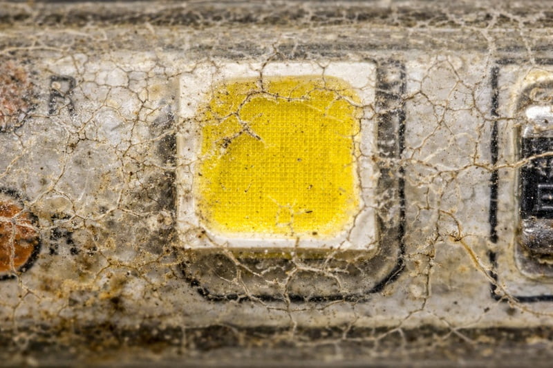 Microscopic view of cracked epoxy coating on LED strip