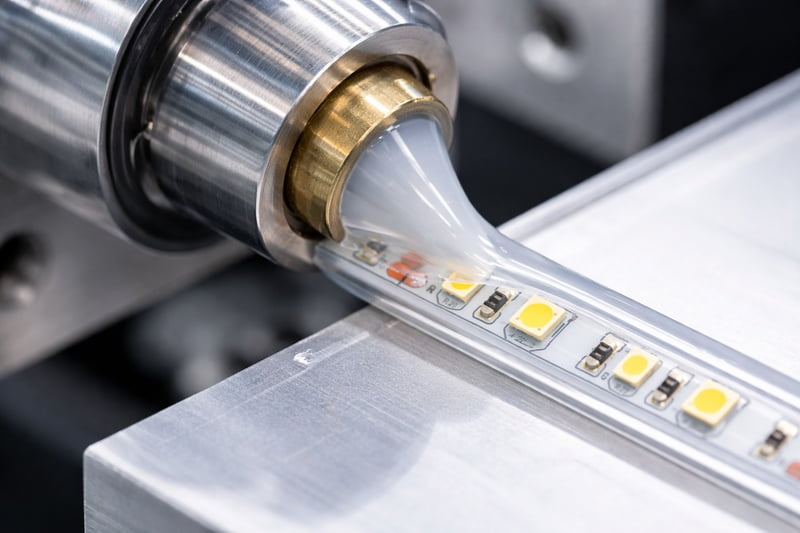 Extrusion machine applying silicone to an LED strip