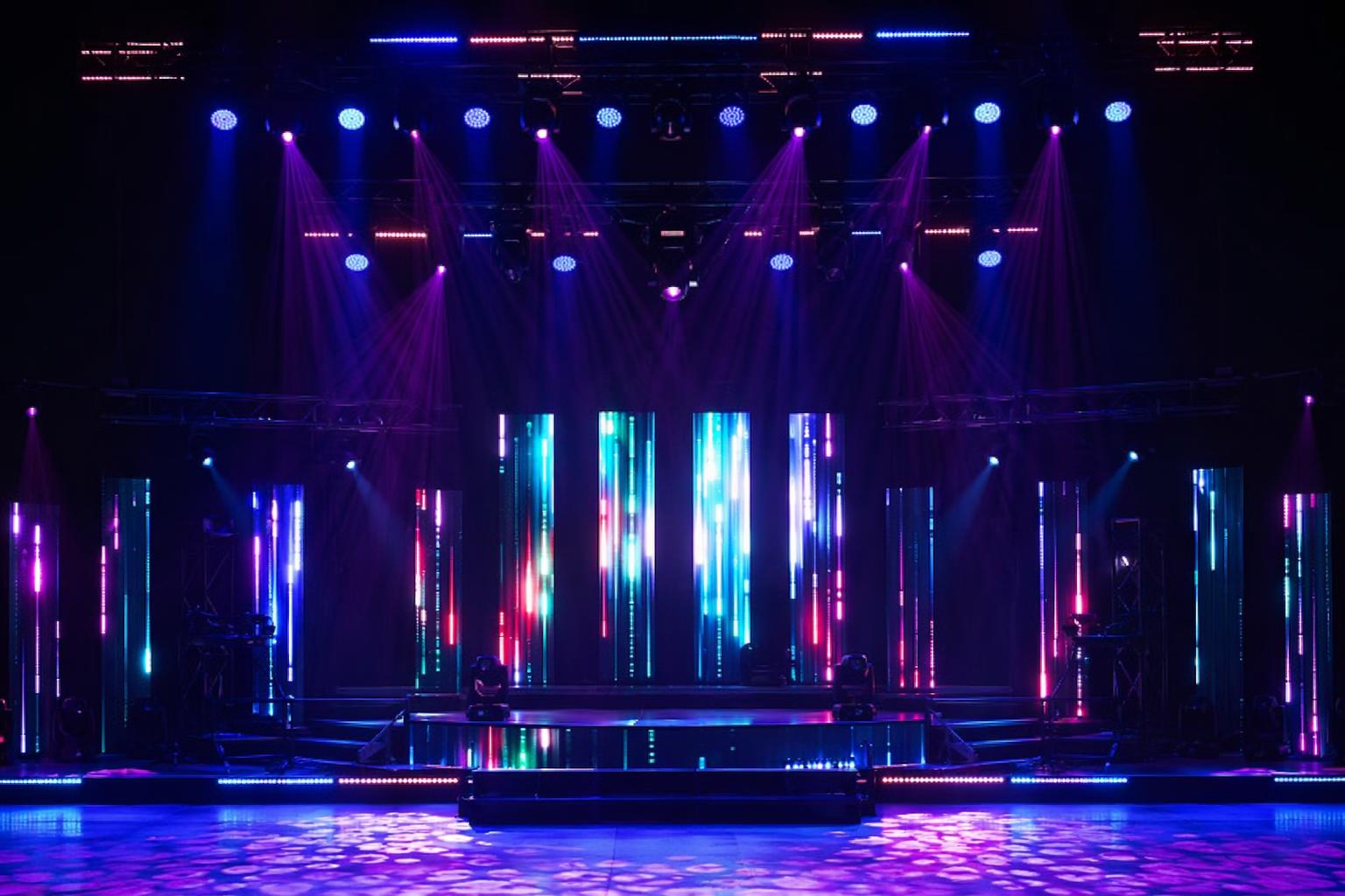 Concert stage and event venue with addressable LED strip lighting creating dynamic programmable pixel effects